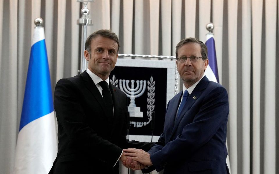 French President Emmanuel Macron, left, shakes hands with Israel's President Isaac Herzog in Jerusalem, Tuesday, Oct. 24, 2023. Emmanuel Macron is traveling to Israel to show France's solidarity with the country and further work on the release of hostages who are being held in Gaza