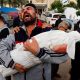 A Palestinian man reacts as he carries the body of his niece Hanan Kaloob, who was killed in an Israeli strike, at Nasser hospital in Khan Younis in the southern Gaza Strip November 22, 2023. REUTERS/Mohammed Salem/File Photo
