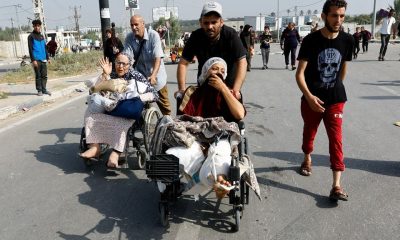 A Palestinian woman, who was injured in an Israeli strike and was staying at Al Shifa hospital, moves southward after fleeing north Gaza as Israeli tanks roll deeper into the enclave, amid the ongoing conflict between Israel and Hamas, in the central Gaza Strip November 10, 2023. REUTERS/Ibraheem Abu Mustafa