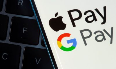 A smartphone with the Apple Pay logo is placed on a displayed Google Pay logo in this illustration taken on July 14, 2021. REUTERS/Dado Ruvic/Illustration/File Photo