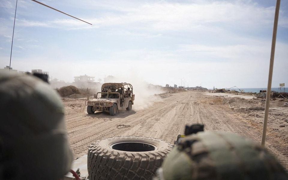 Israeli soldiers drive a military vehicle, amid the ongoing ground operation of the Israeli army against Palestinian Islamist group Hamas, in the Gaza Strip as seen in a handout picture released by the Israel Defense Forces on November 13, 2023. Israel Defense Forces/Handout via REUTERS