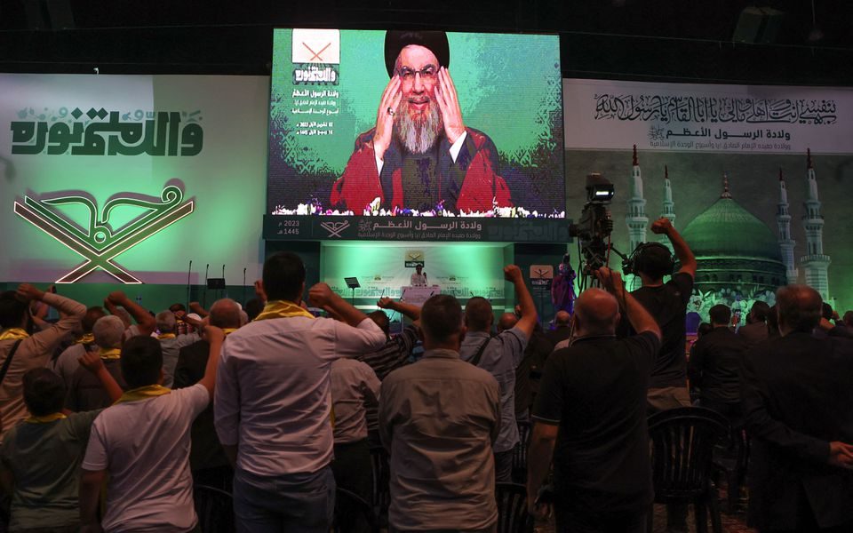 Lebanon's Hezbollah leader Sayyed Hassan Nasrallah addresses his supporters via a screen during a rally marking Prophet Mohammed's birthday, in Beirut suburbs, Lebanon October 2, 2023. REUTERS/Mohamed Azakir/File Photo