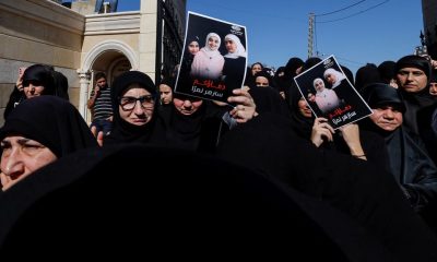 Mourners hold photographs of three Lebanese girls who were killed along with their grandmother in what Lebanese authorities said was an Israeli strike that hit their car on Sunday, as they mourns during their funeral, in the southern town of Blida, Lebanon November 7, 2023. REUTERS/Zohra Bensemra