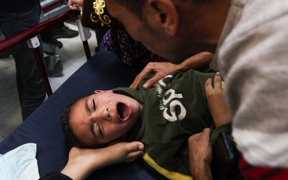 A Palestinian boy is assisted following an Israeli strike, amid the ongoing conflict between Israel and the Palestinian Islamist group Hamas, at Nasser hospital in Khan Younis in the southern Gaza Strip, December 3, 2023. REUTERS/Ibraheem Abu Mustafa