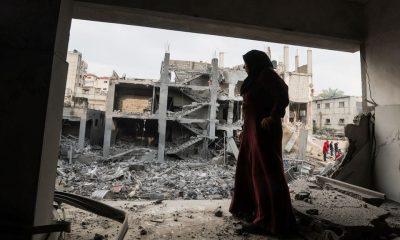 A Palestinian woman stands at the site of Israeli strikes on houses in Khan Younis, in the southern Gaza Strip December 14, 2023. REUTERS/Ibraheem Abu Mustafa