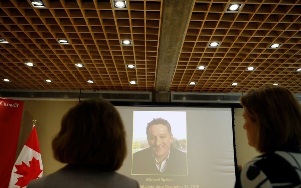 An image of Canadian Michael Spavor, charged with espionage in June 2019, is projected on a screen at the Canadian embassy in Beijing, China August 11, 2021. REUTERS/Florence Lo/File Photo