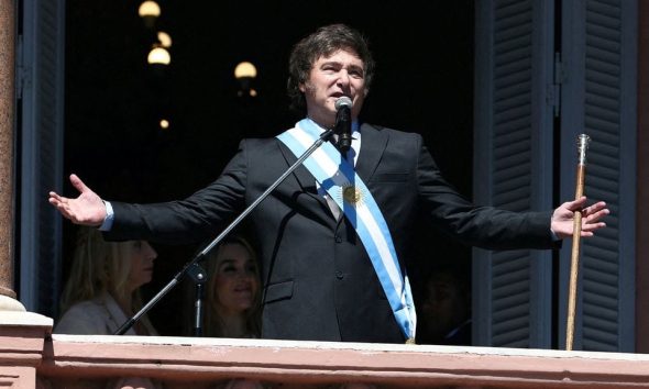 Argentina's President Javier Milei addresses supporters from the Casa Rosada balcony, as his sister Karina Milei and his partner Fatima Florez look on, after his swearing-in ceremony, in Buenos Aires, Argentina December 10, 2023. REUTERS/Agustin Marcarian/File Photo