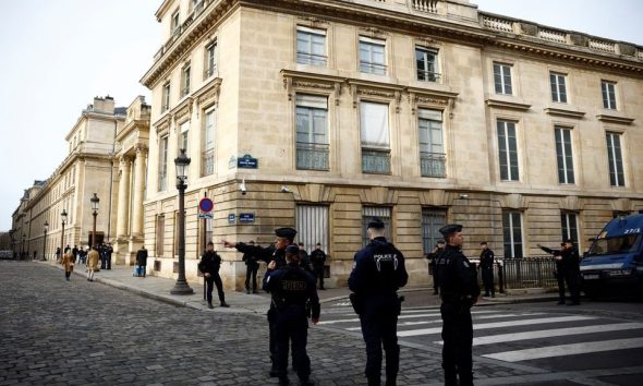 French police stand in position near the National Assembly as protesters gather before the start of a debate on the immigration law in Paris, France, December 11, 2023. REUTERS/Sarah Meyssonnier