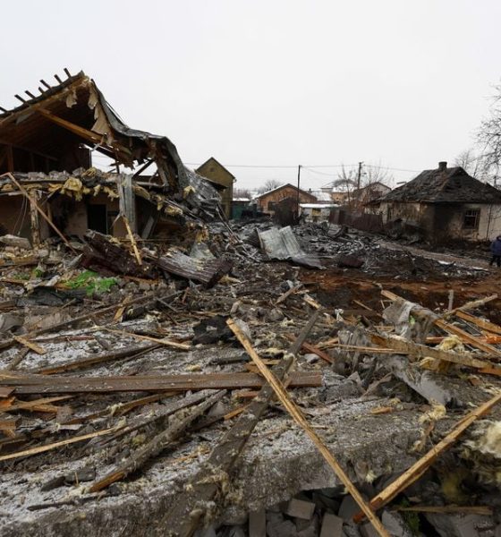 Local residents stand at a site of residential buildings, heavily damaged by a Russian missile strike, amid Russia's attack on Ukraine, in Kyiv, Ukraine December 11, 2023. REUTERS/Valentyn Ogirenko