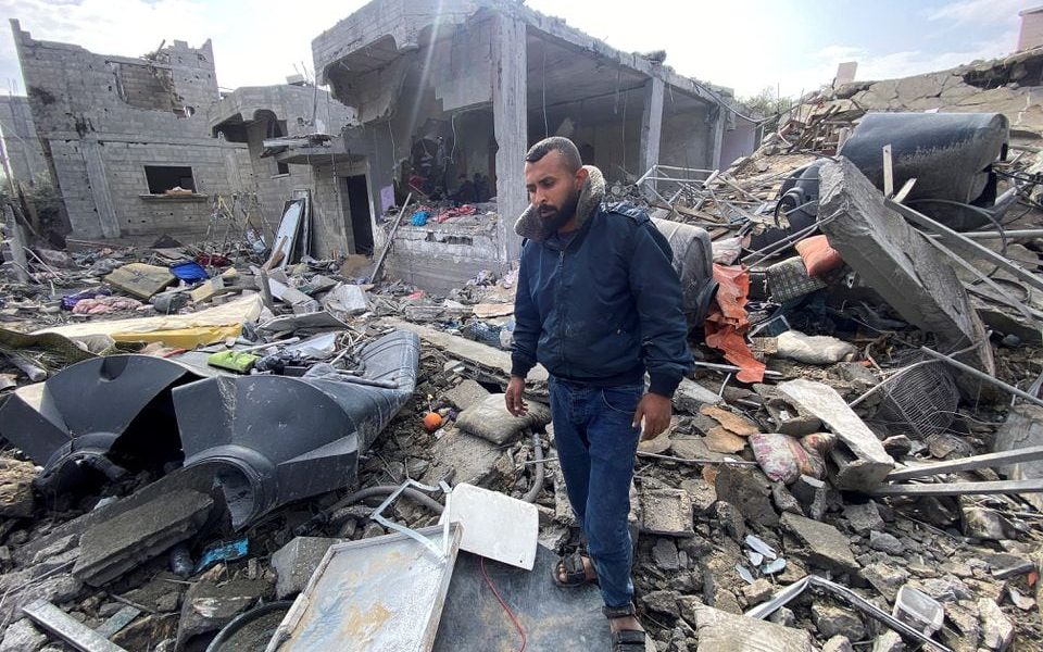 Palestinian man Ibrahim Al-Haj Youssef, who lost four of his children and his wife in an Israeli air strike, stands amidst debris, amid the ongoing conflict between Israel and Hamas, at the Maghazi camp, in the central Gaza Strip, December 25, 2023. REUTERS/Doaa Ruqaa