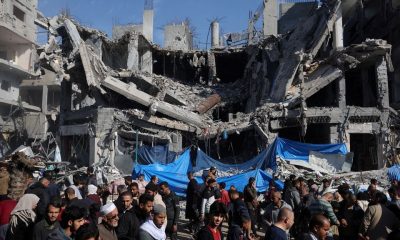 Palestinians shop in an open-air market near the ruins of houses and buildings destroyed in Israeli strikes during the conflict, amid a temporary truce between Hamas and Israel, in Nuseirat refugee camp in the central Gaza Strip November 30, 2023. REUTERS/Ibraheem Abu Mustafa