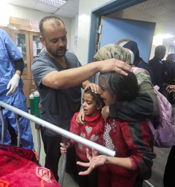 People react next to the bed of a Palestinian wounded in an Israeli strike, at a hospital in Khan Younis, amid the ongoing conflict between Israel and the Palestinian Islamist group Hamas, in the southern Gaza Strip, December 28, 2023. REUTERS/Ahmed Zakot