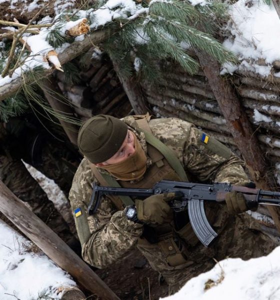 A Ukrainian soldier holds AK-47 rifle in a trench during Combined Arms Training in Wedrzyn, Poland, December 7, 2023. REUTERS/Kuba Stezycki