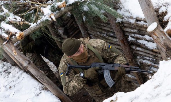 A Ukrainian soldier holds AK-47 rifle in a trench during Combined Arms Training in Wedrzyn, Poland, December 7, 2023. REUTERS/Kuba Stezycki